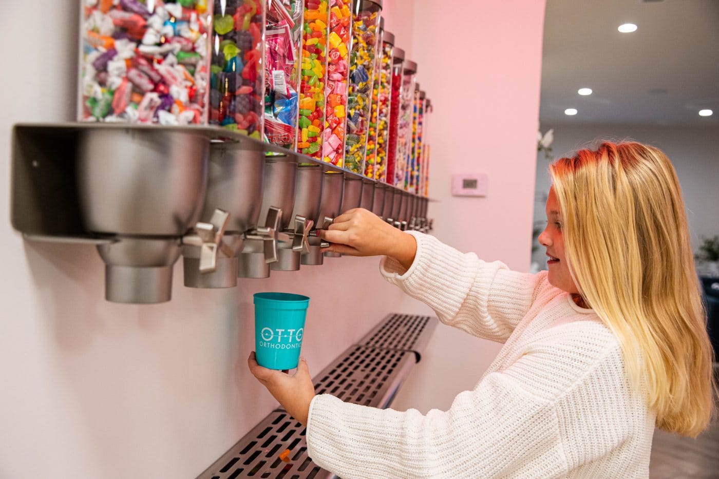 Child getting candy from candy dispenser