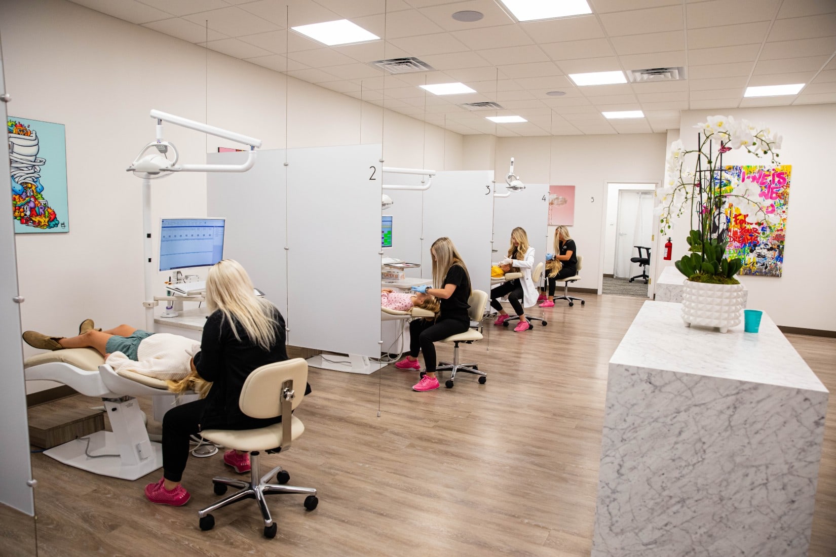 4 exam rooms with patients being seen