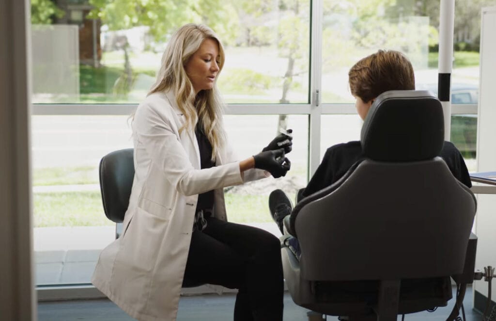 Dr. Otto speaking with a young patient
